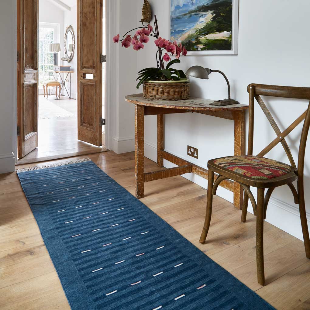 cosmo indigo striped rug in a hallway