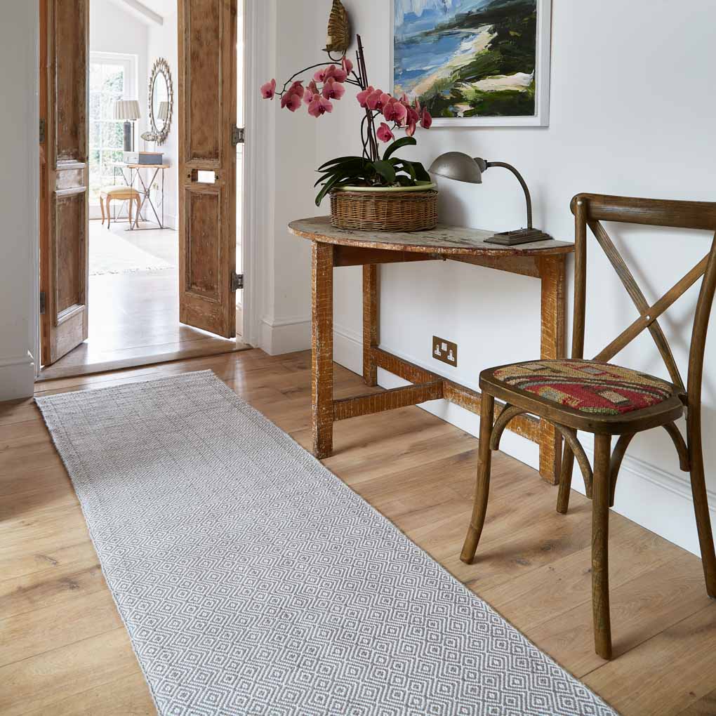 beige diamond patterned rug in a hallway
