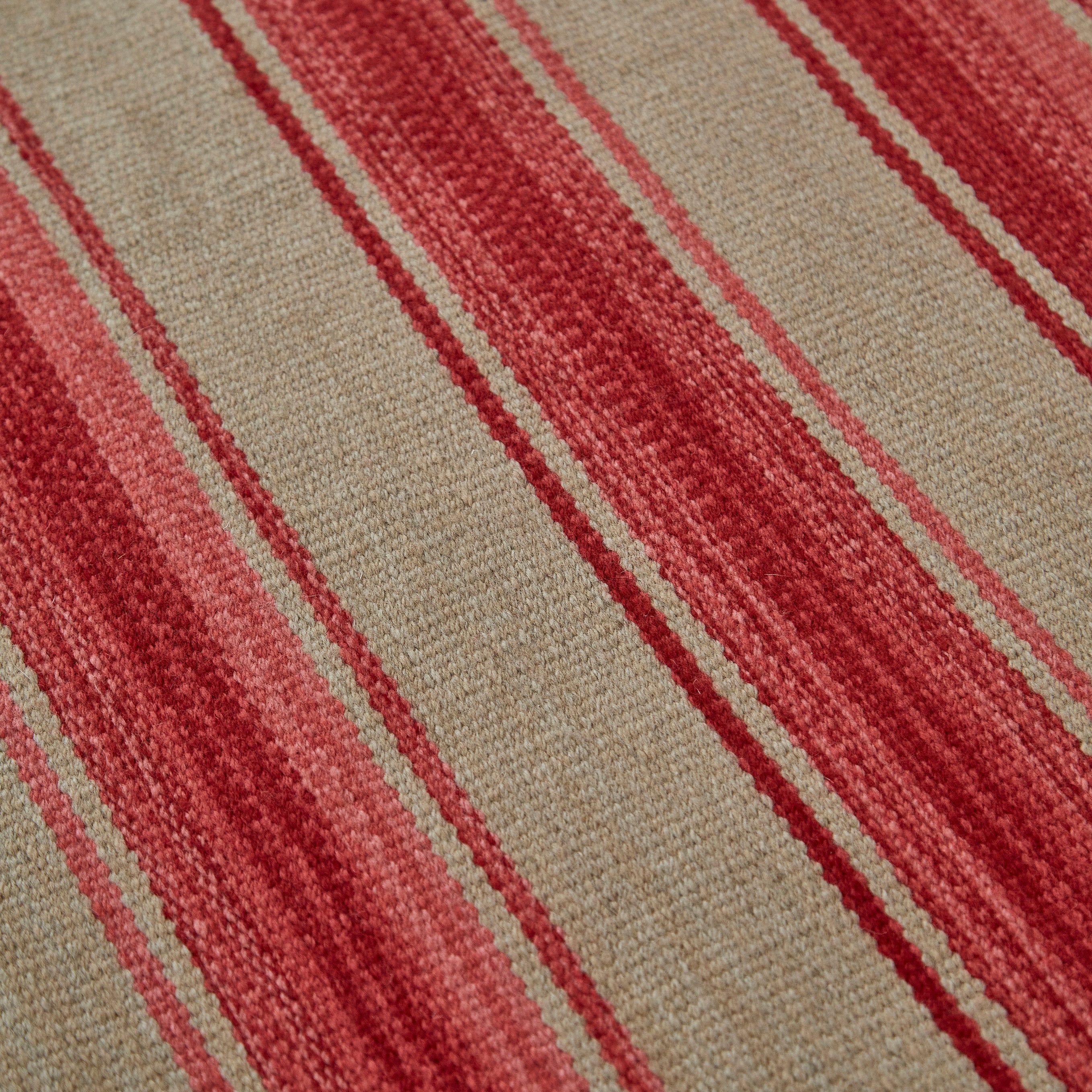 Close-up of red, pink and beige striped Weaver Green rug.