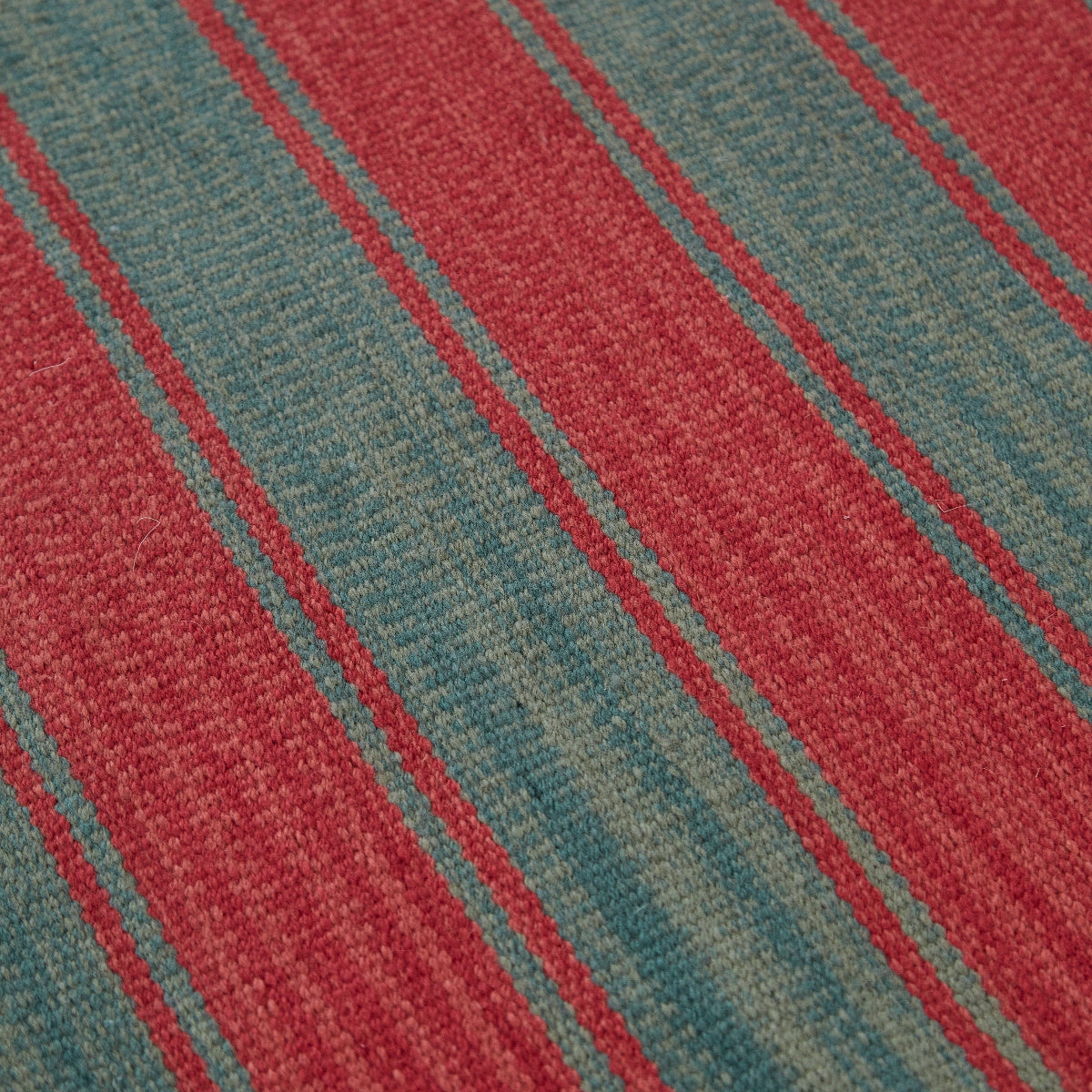 Close-up of a red and green striped rug.