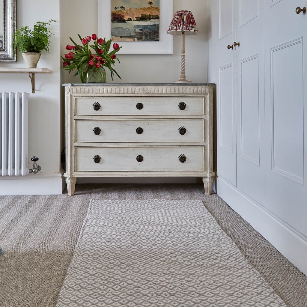 beige patterned runner in bedroom