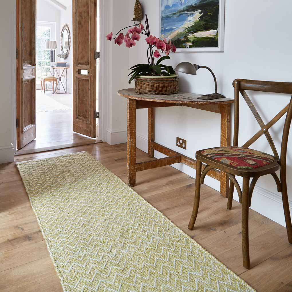 a yellow chevron rug in a hallway