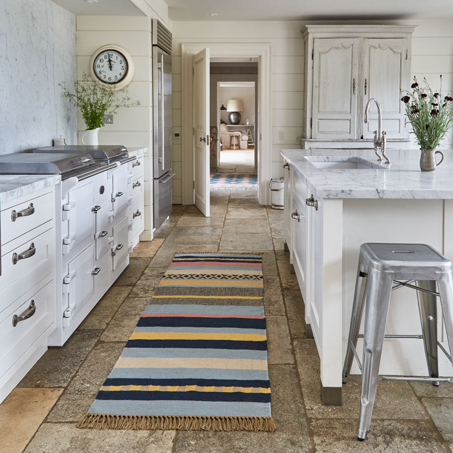 A stripey blue runner in a kitchen