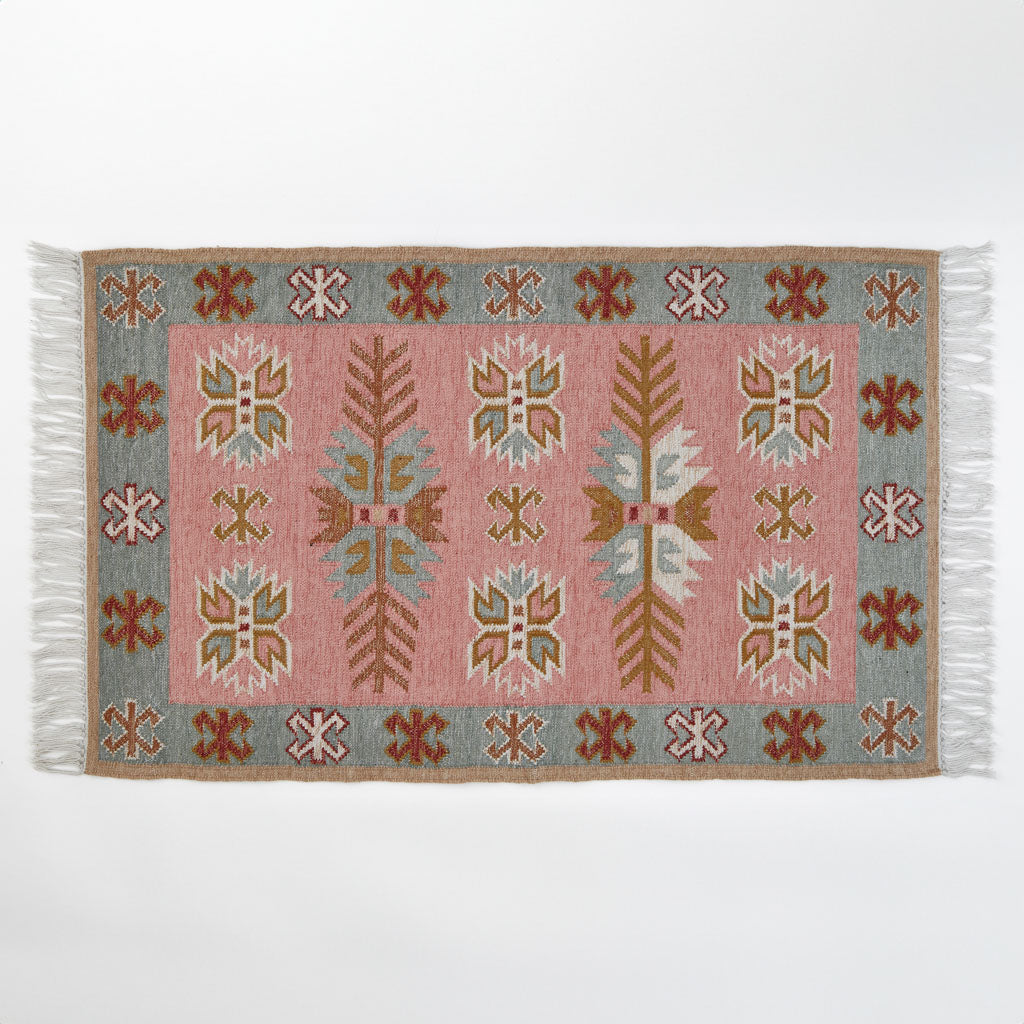 A pink, pale blue and neutral coloured rug