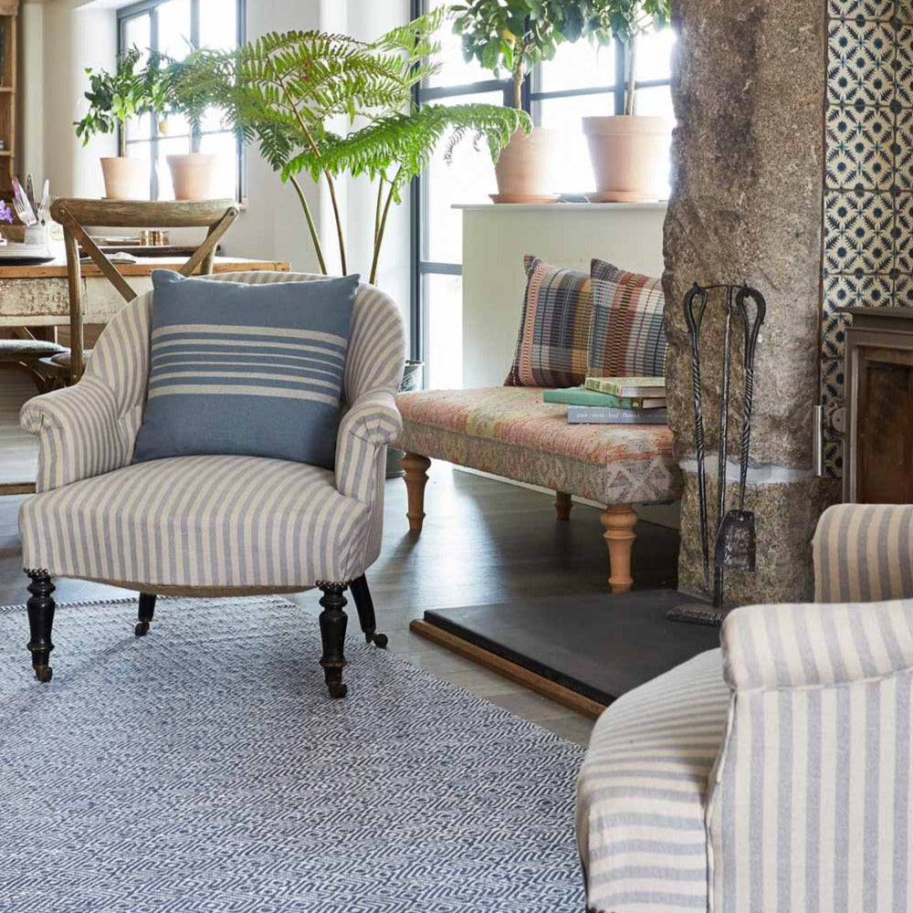 navy provence rug in living room with fireplace and armchair