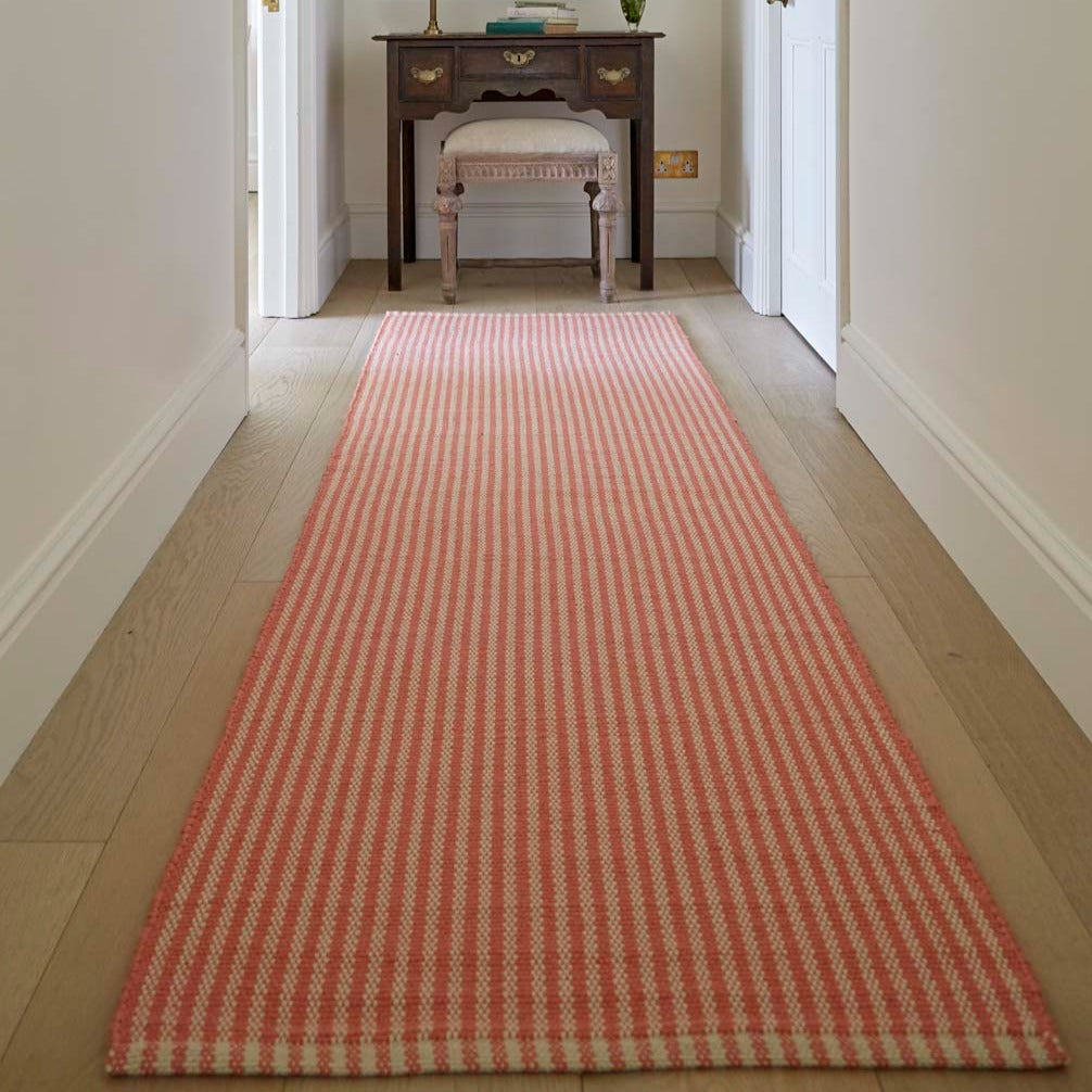 striped coral rug in a hallway