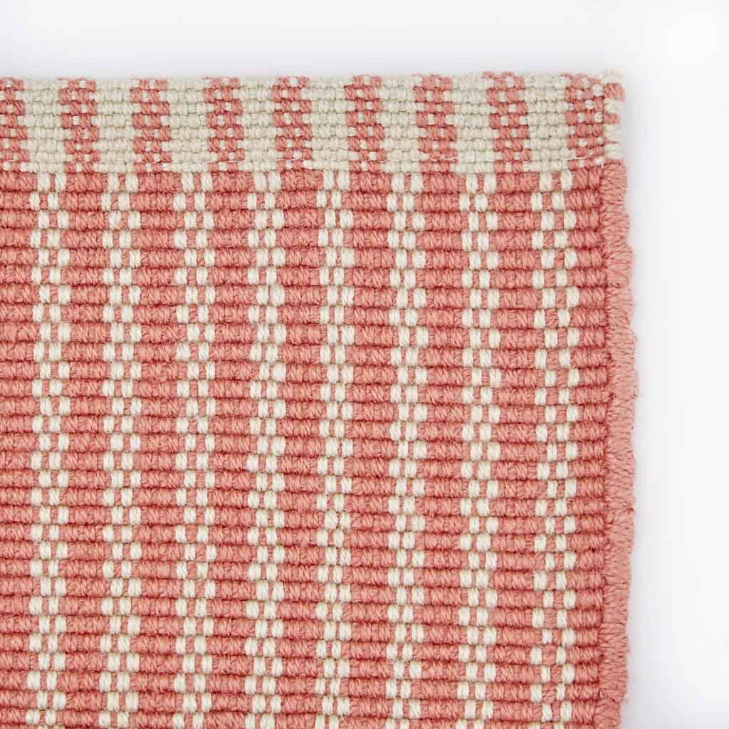 striped coral rug corner detail