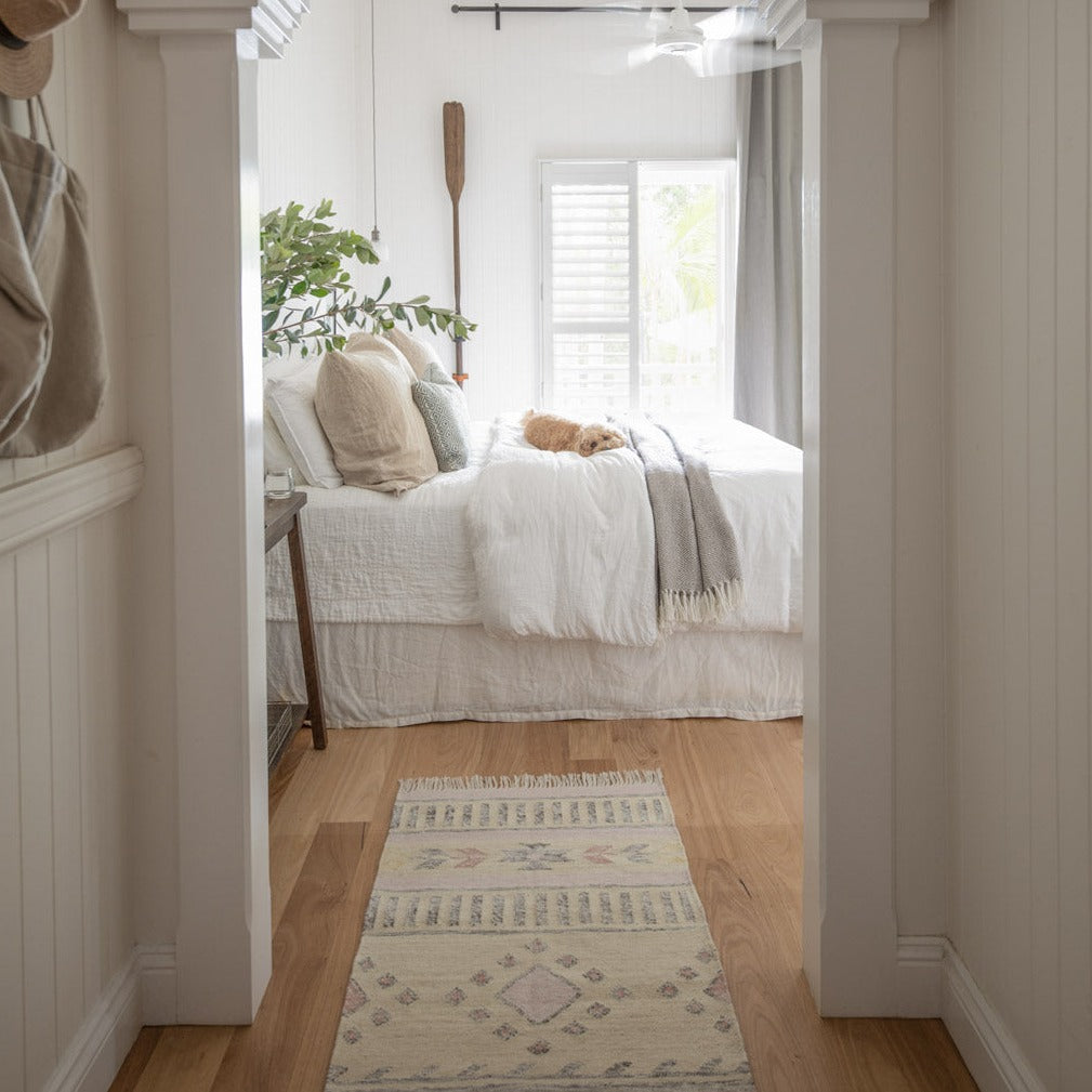 A hallway rug leading to the bedroom
