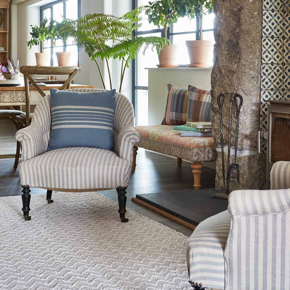 armchairs on soft chenille rug next to a fireplace in the living room