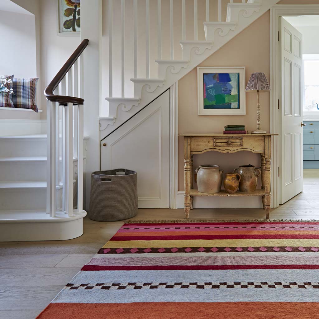 Bright stripey rug in the hallway.