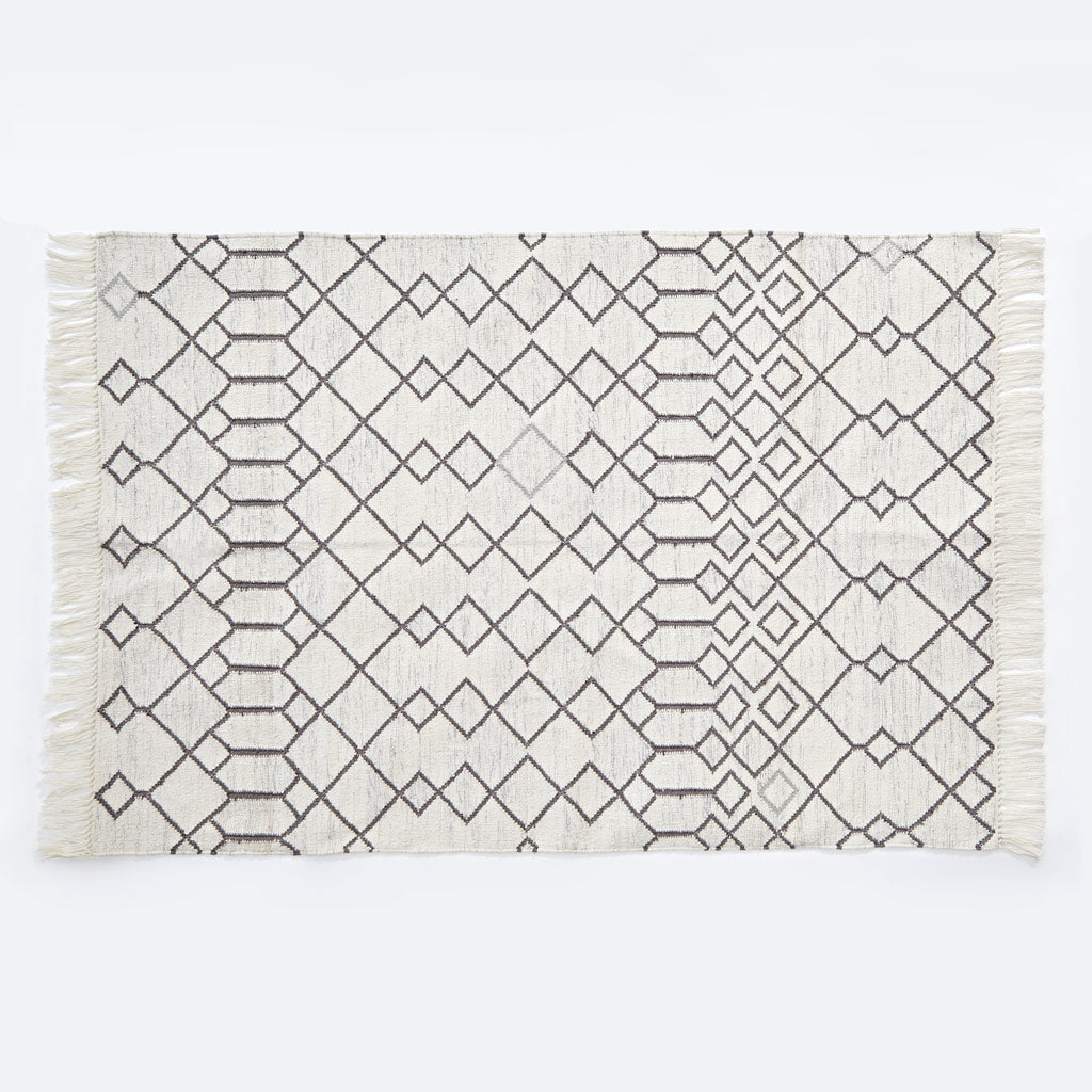 white geometric rug with diamond pattern
