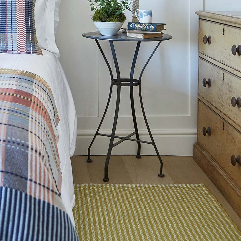 yellow striped rug in a bedroom