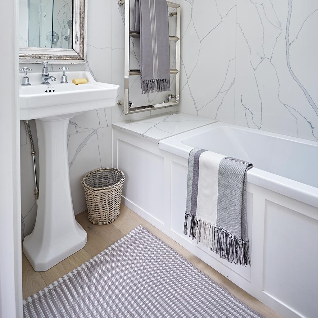striped rug in a monochrome bathroom