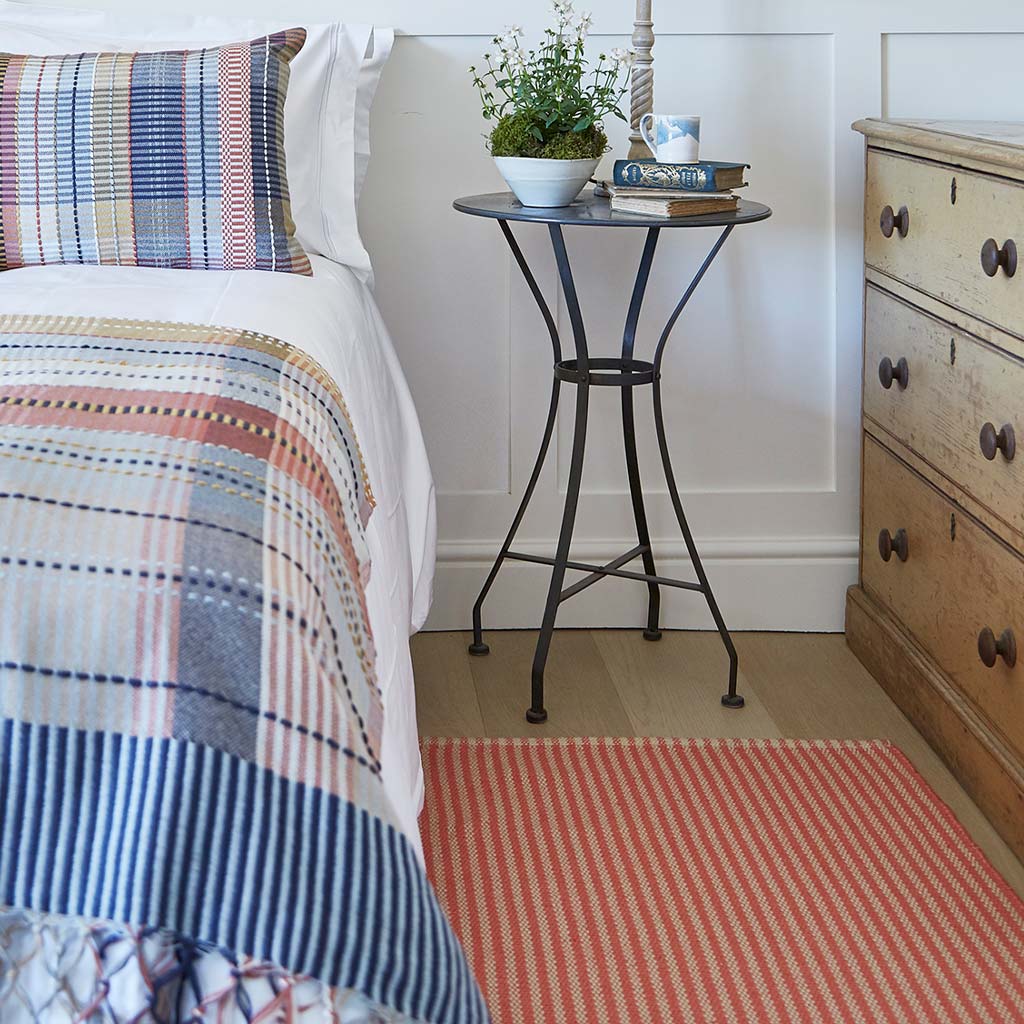 striped coral rug in a country bedroom