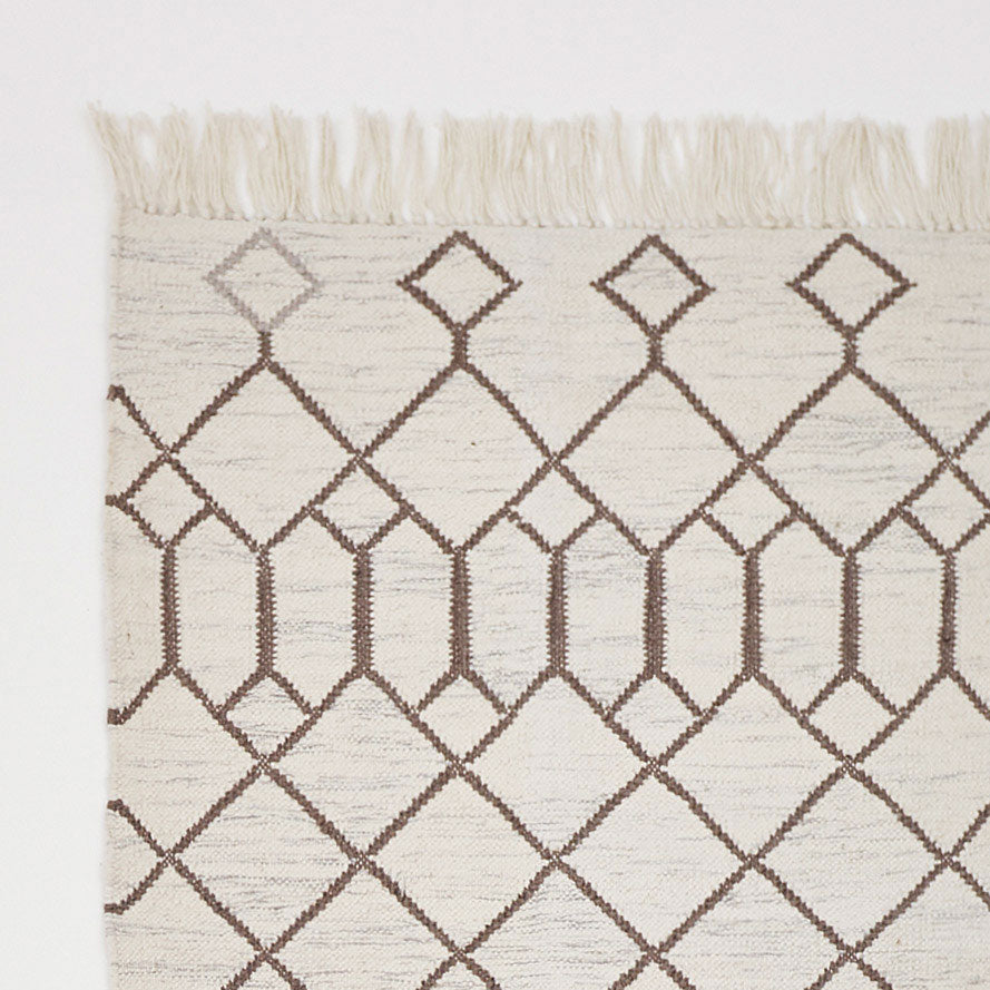 white geometric rug with diamond pattern