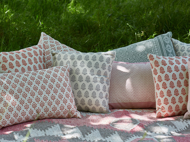 Jaipur Acorn cushions in coral on sun lounger