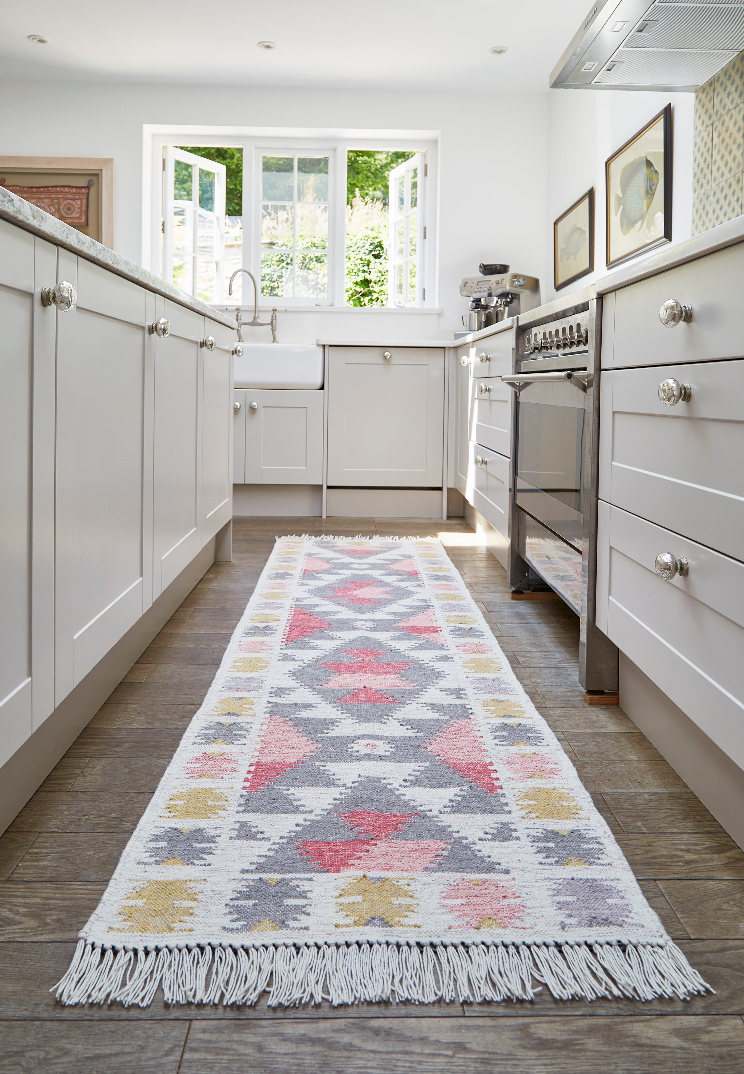 Kitchen with an Andalucia Zahara kilim runner rug on a wooden floor.