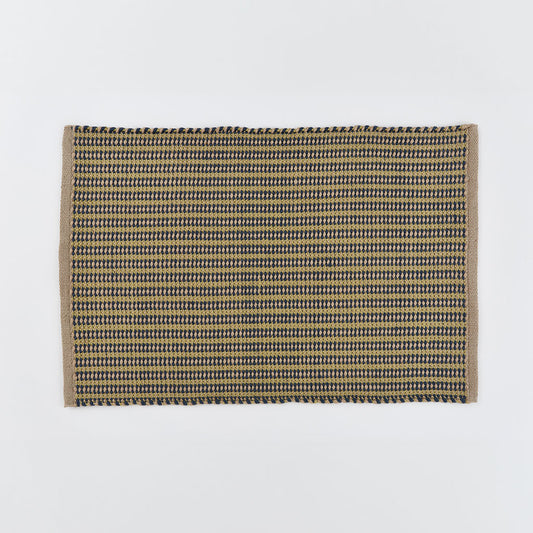 A striped rug in navy blue and gooseberry yellow 