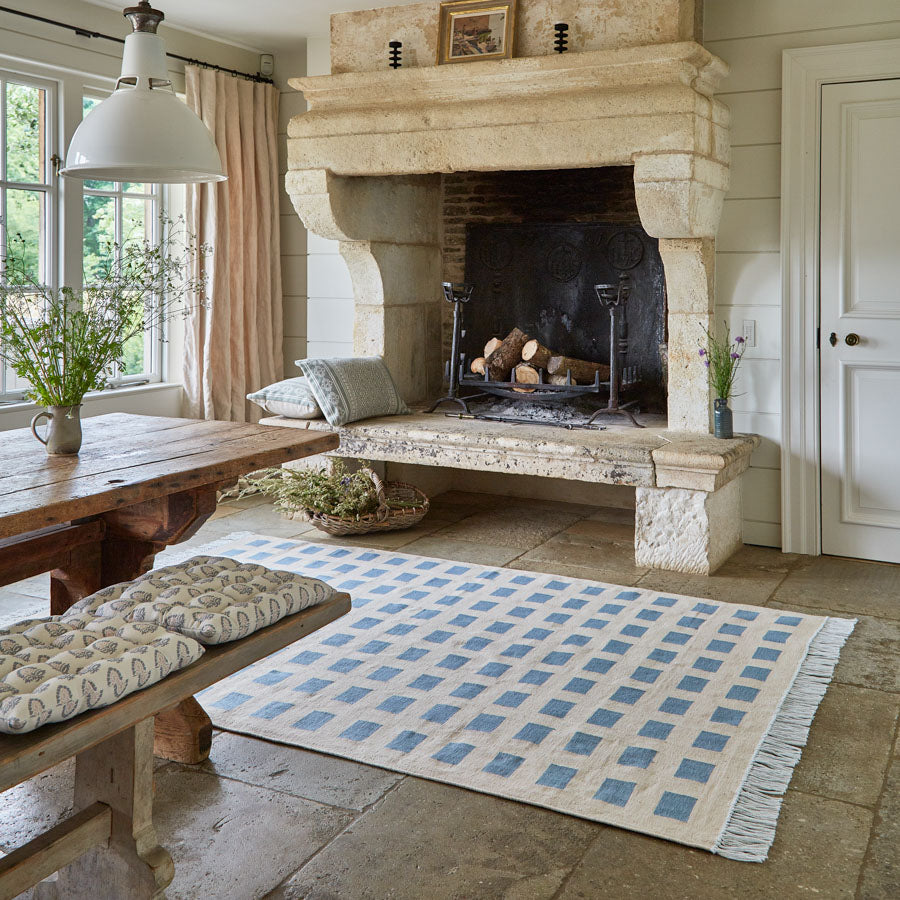 neutral and blue checkered rug in a kitchen diner 