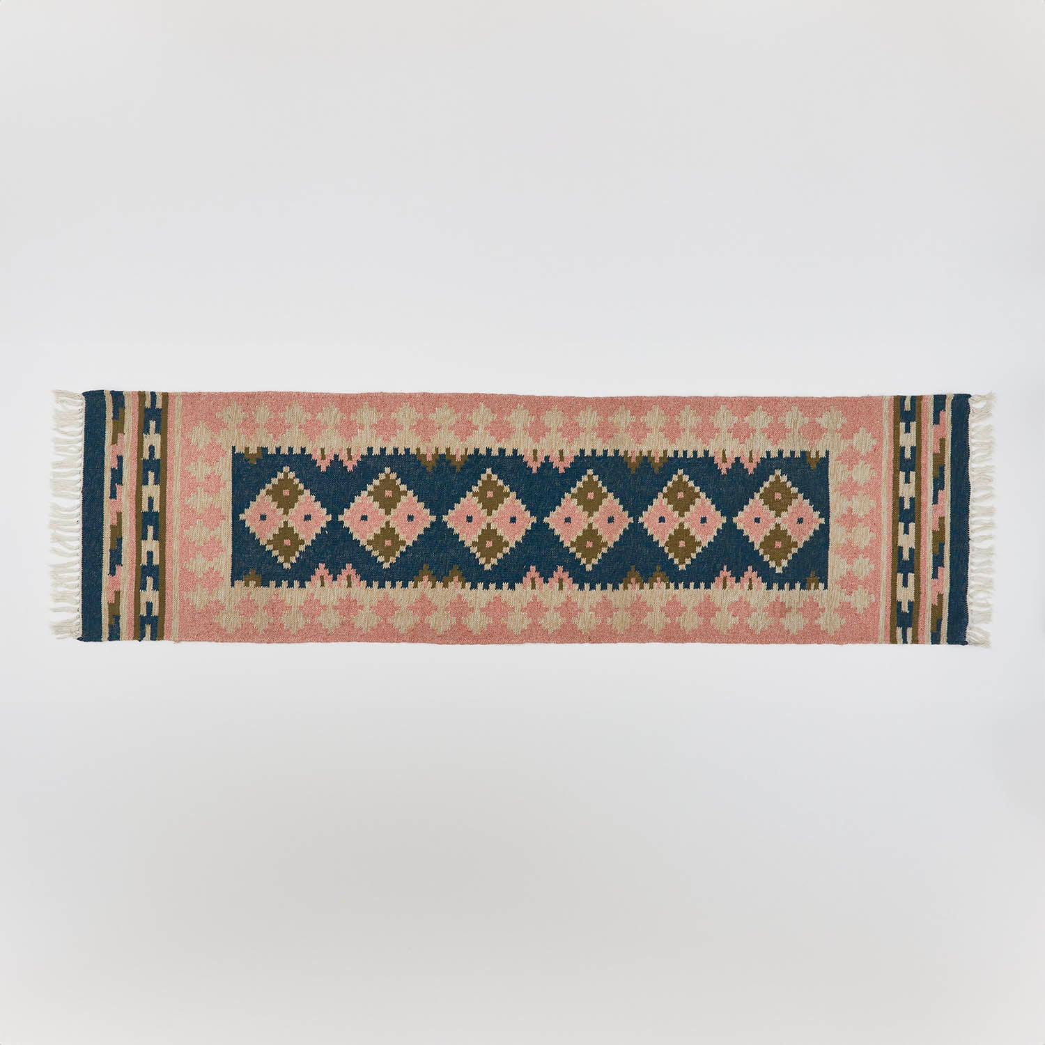 a plaster pink and dark blue geometric rug 