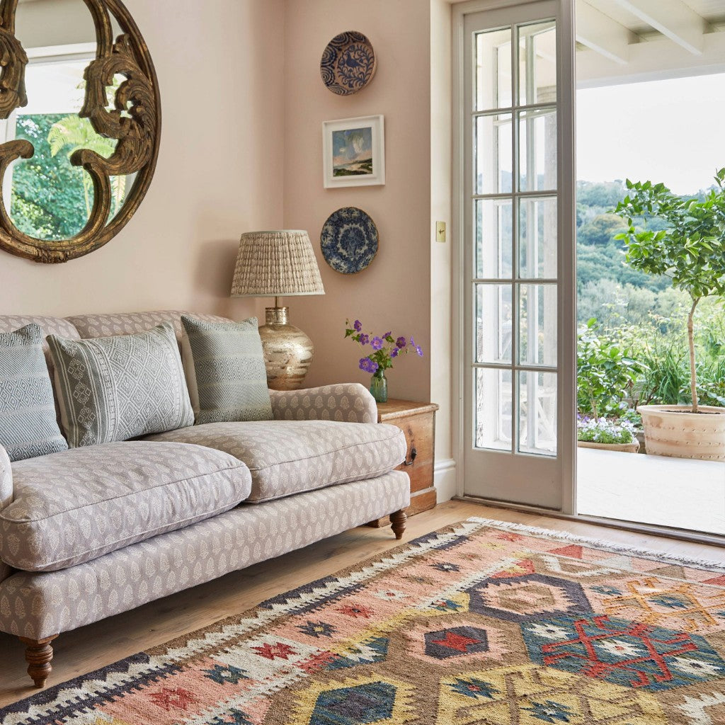 Living room with a sofa, rug, and decorative elements.