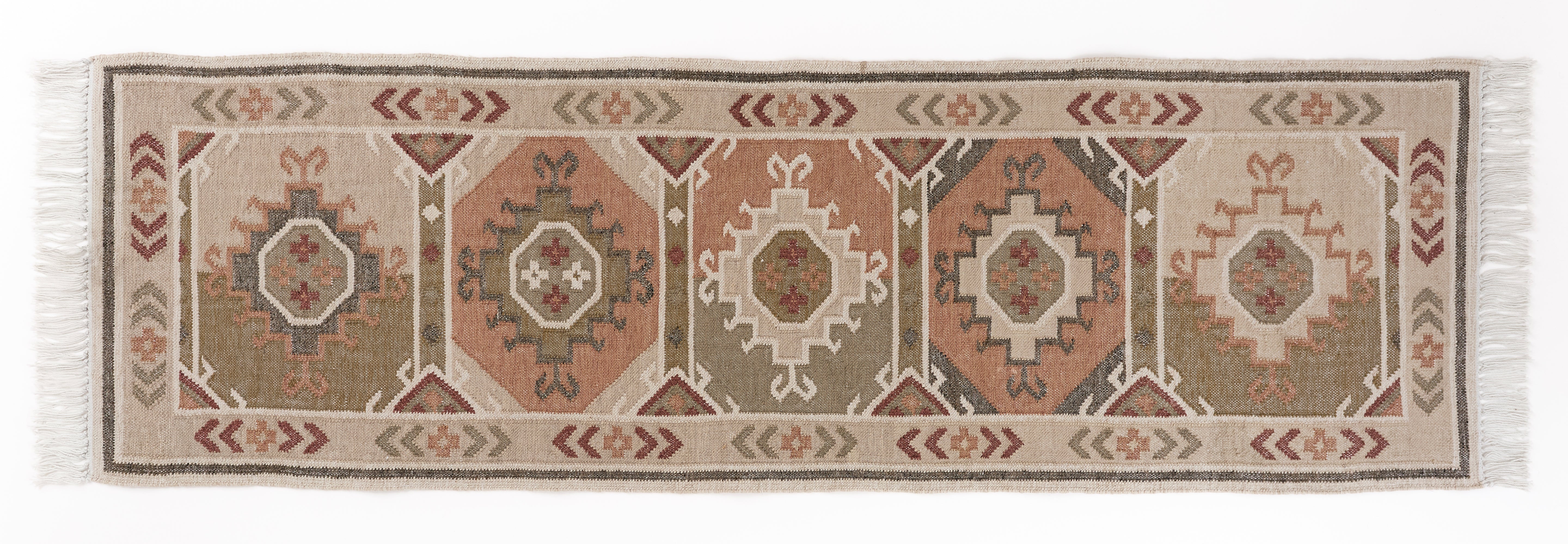 Neutral runner rug with a geometric kilim motif pattern placed on a white background.