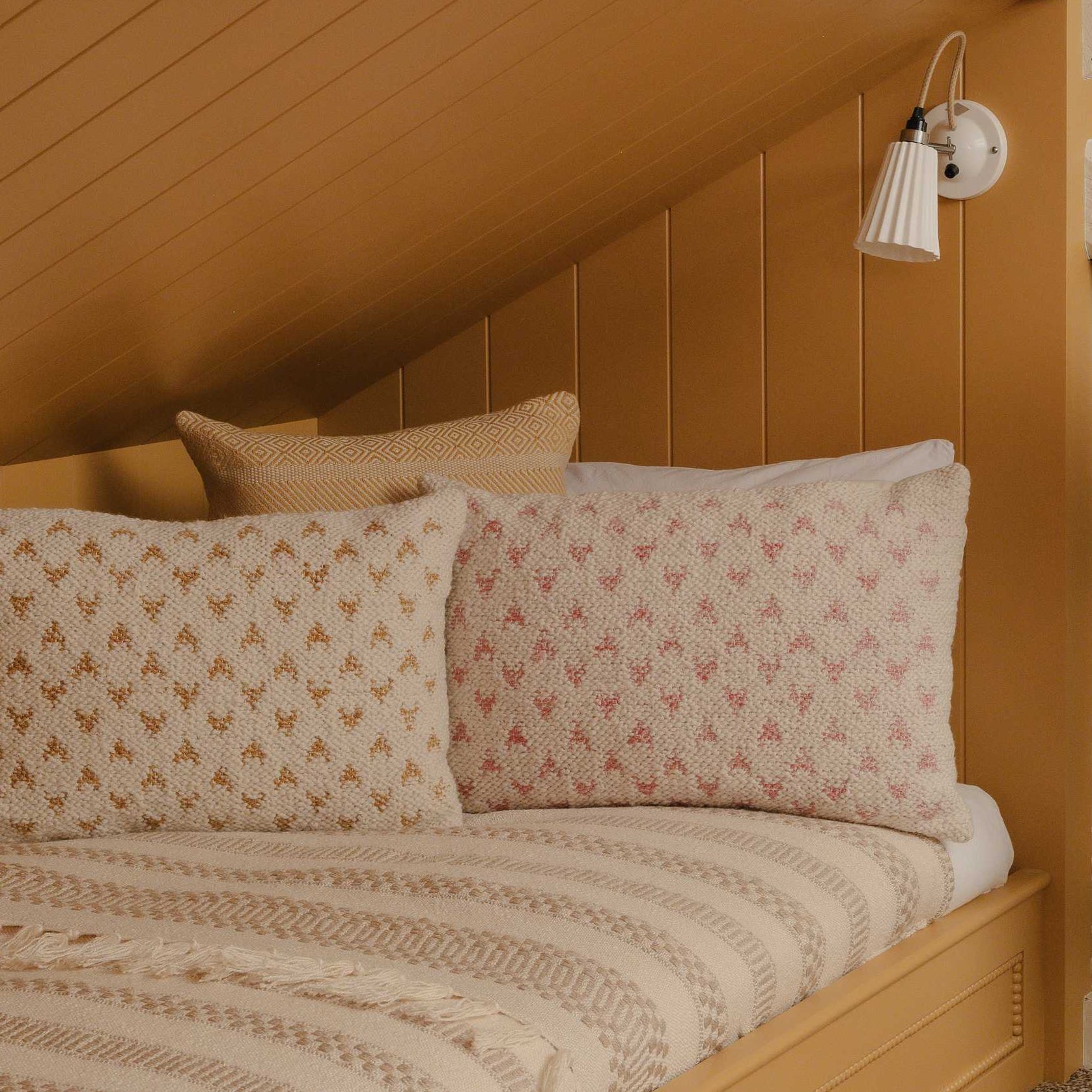 Wooden Murphy bed with striped curtains in a cozy room.