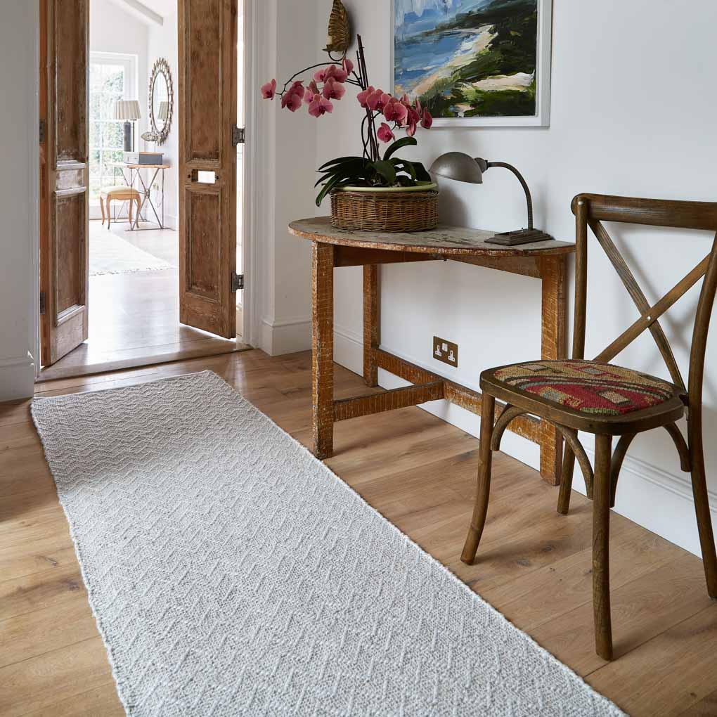 beige herringbone runner in hallway