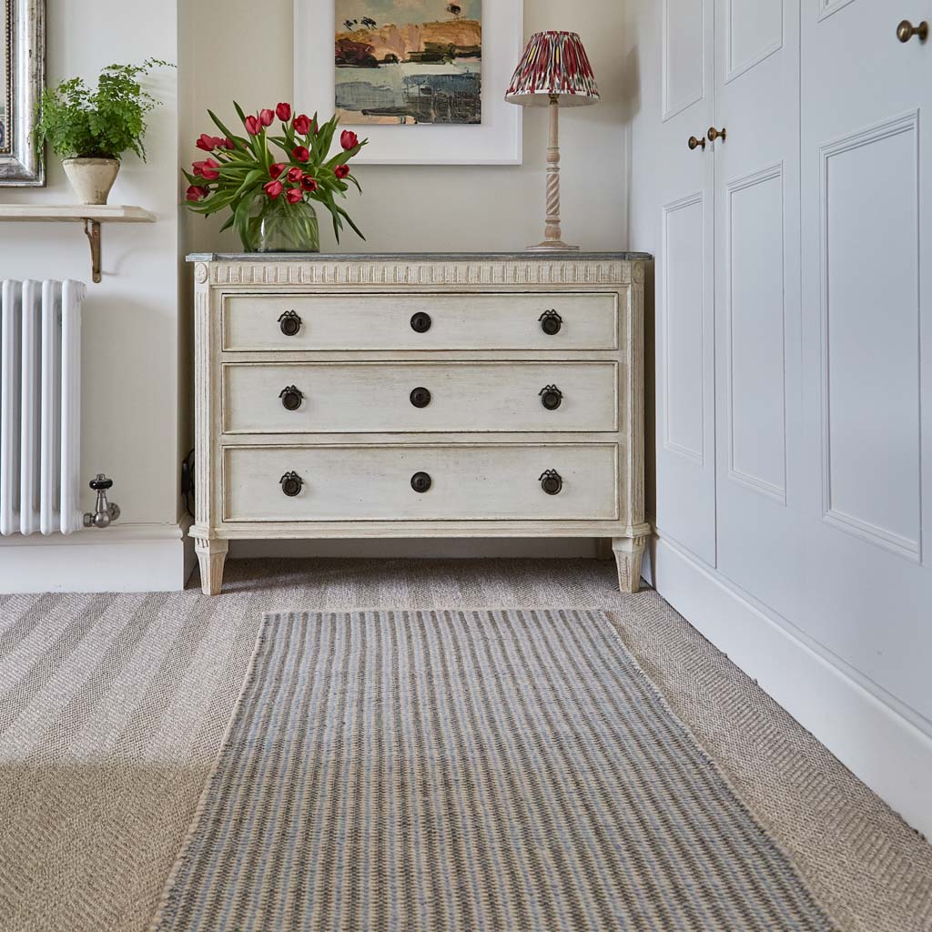 grey and blue striped runner in bedroom 