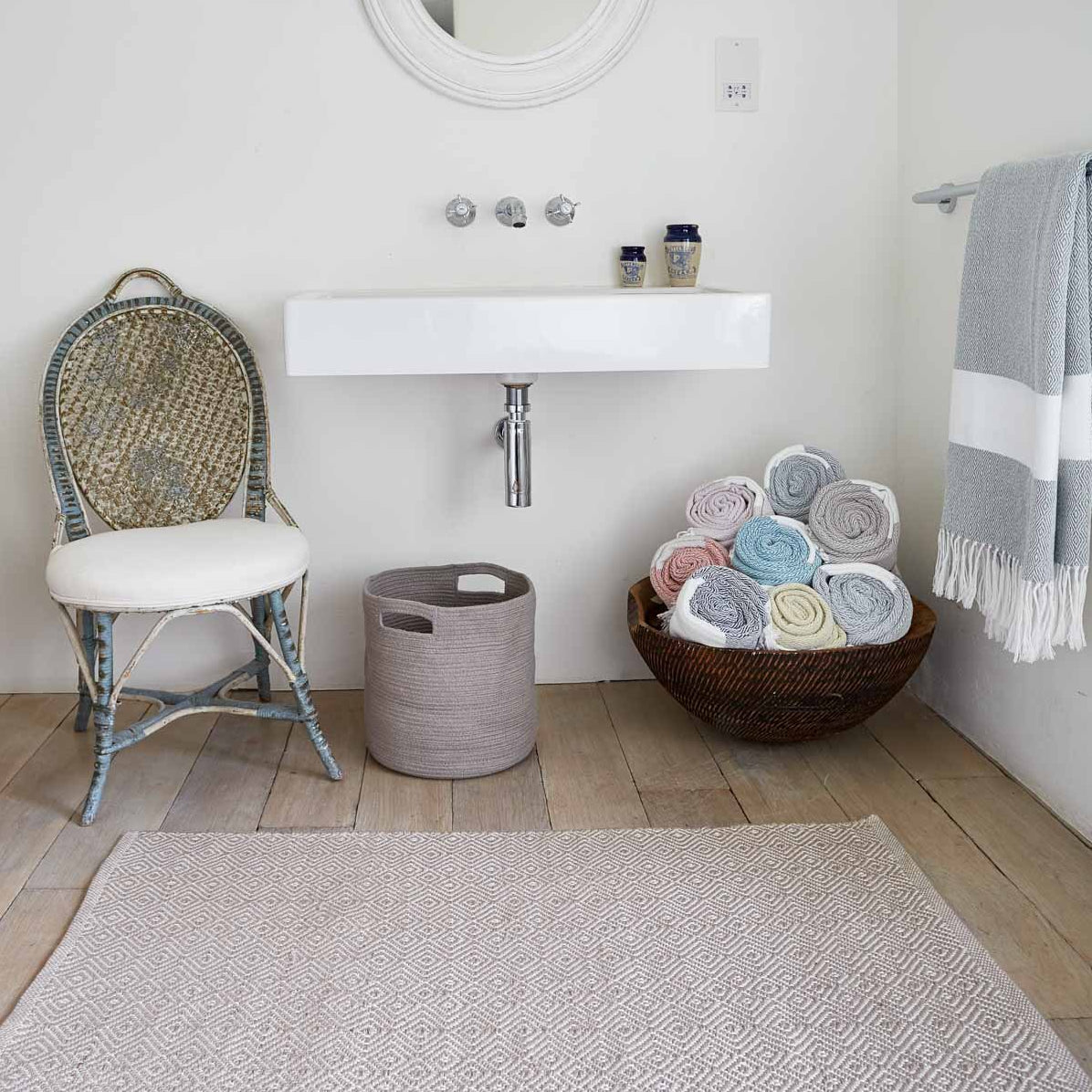 Dormouse Diamond Bathroom Rug with chair and Weaver Green Hammam Throws