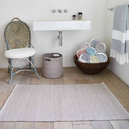 Dormouse Herringbone Rug in bathroom with Weaver Green Hammam Throws