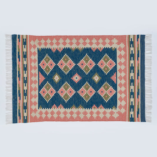 a plaster pink and dark blue geometric rug 