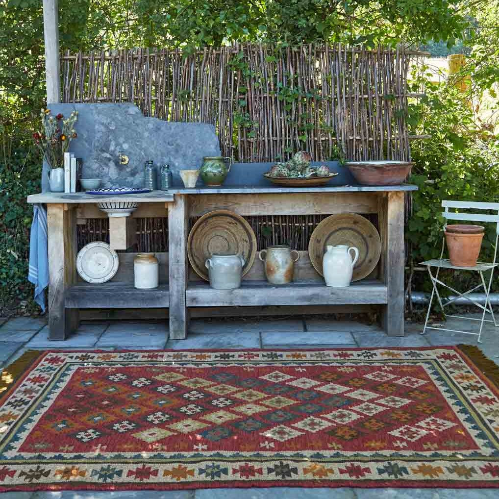 Red patterned kilim rug outdoors 