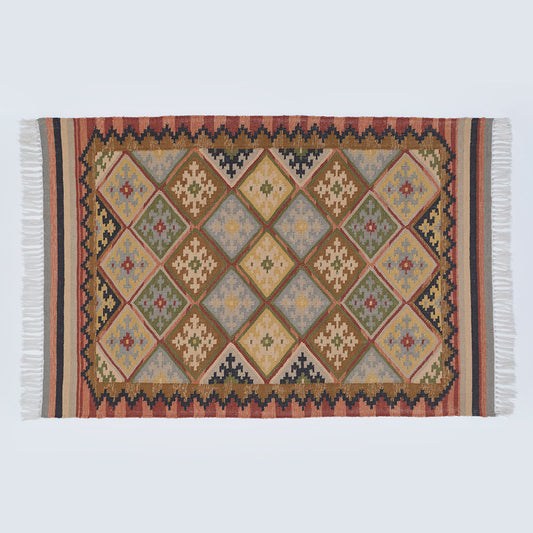 Geometric patterned rug in neutral brown, olive and yellow tones 
