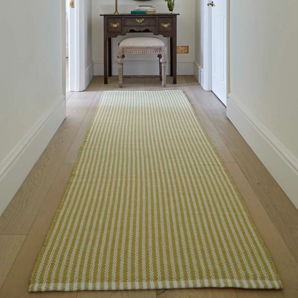 yellow striped rug in the hallway 