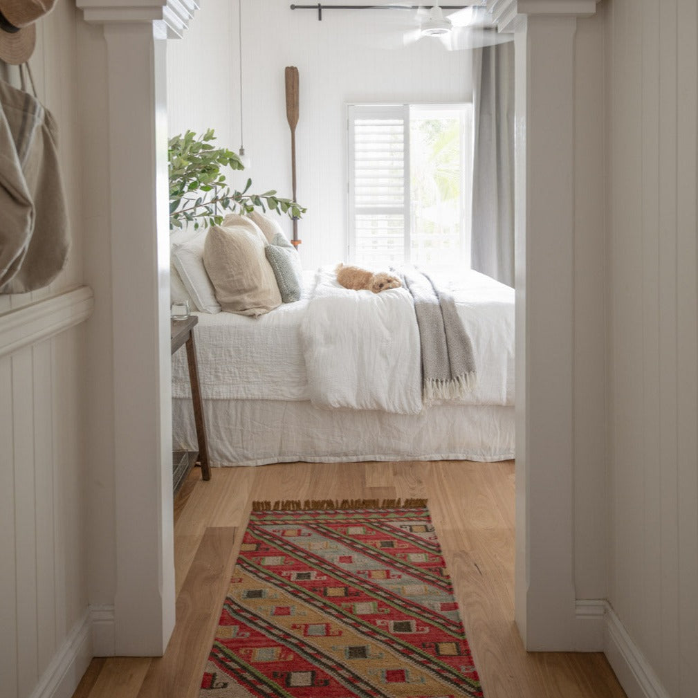 red nomad runner leading into a bedroom 